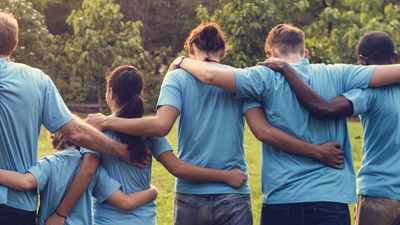 Group of people holding onto each other's shoulders